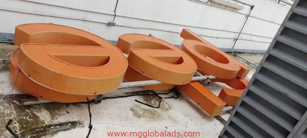 Large orange channel letters signage spelling doc on a rooftop in Makati, awaiting installation by M&G Global Ads.