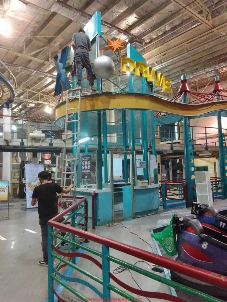 Acrylic DRIVE LED neon signage installation in an indoor amusement center with bumper cars, Makati, by M&G Global Ads.