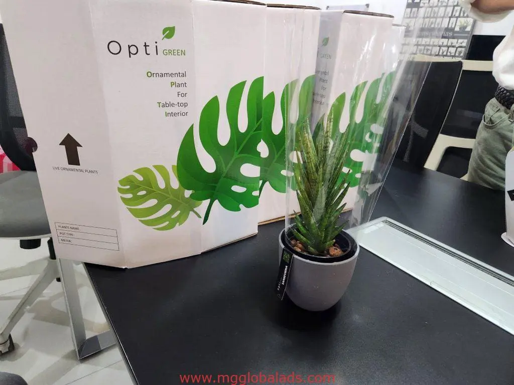 Opti Green LED signage display with branded boxes and plant on table in Quezon City, by M&G Global Ads.