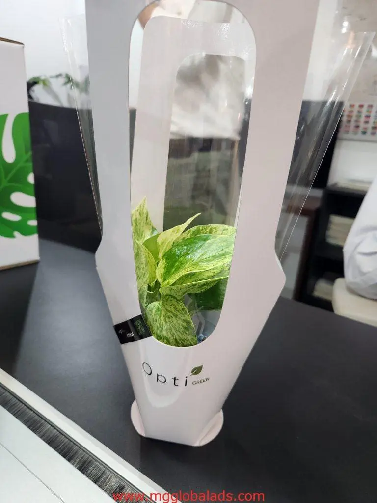 Acrylic signage display with Opti Green potted plant in Makati office setting by M&G Global Ads.