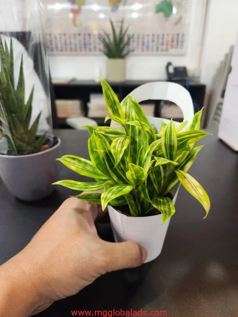 Hand holding a plant in white pot, LED signage in background, Quezon City location, by M&G Global Ads.