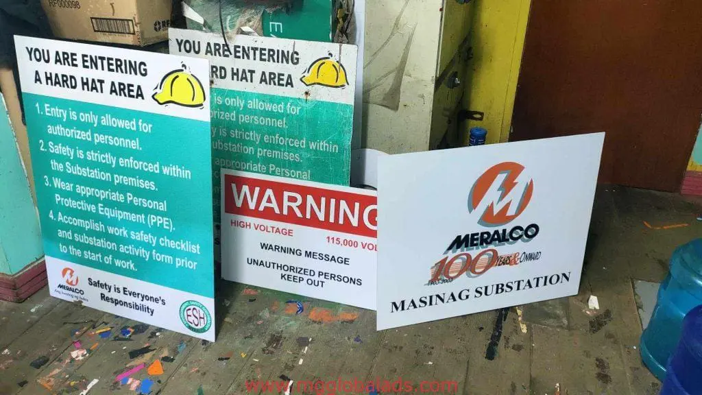 Safety and building signage for Meralco, including hard hat notice and high voltage sign in Ortigas by M&G Global Ads.