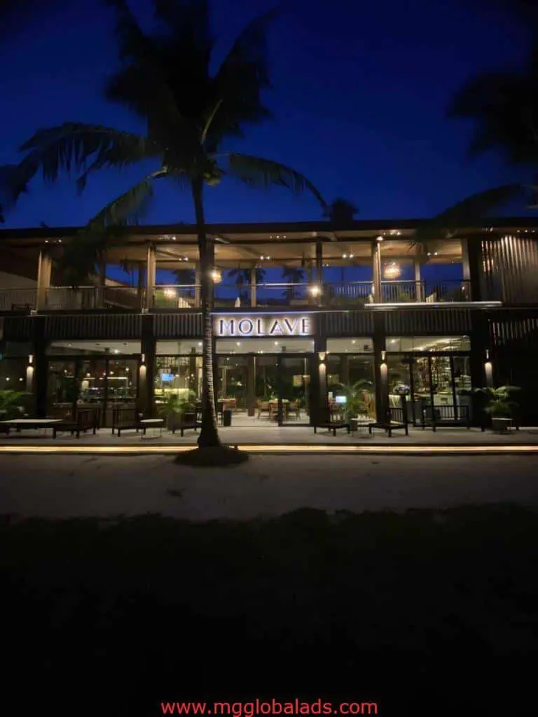 Molave restaurant with LED signage, warmly lit at night in Makati, inviting entrance and windows, by M&G Global Ads.