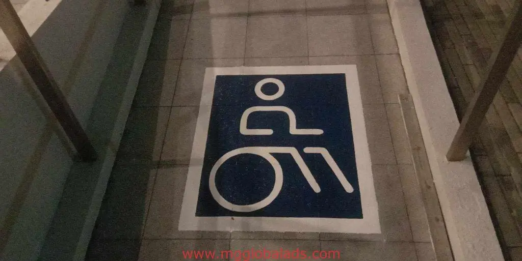 Indoor wheelchair accessibility signage on tiled floor in Quezon City, ideal for disability access pathways by M&G Global Ads.
