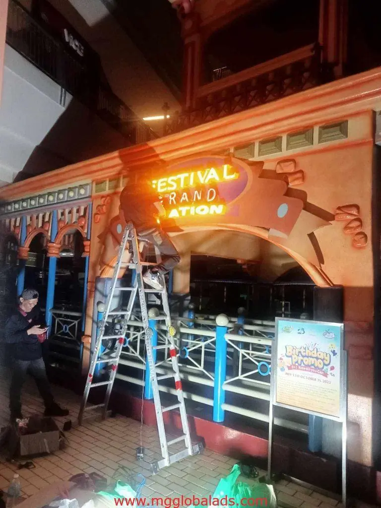 LED neon signage installation for FESTIVAL GRAND STATION at a decorative entrance in Mandaluyong by M&G Global Ads.