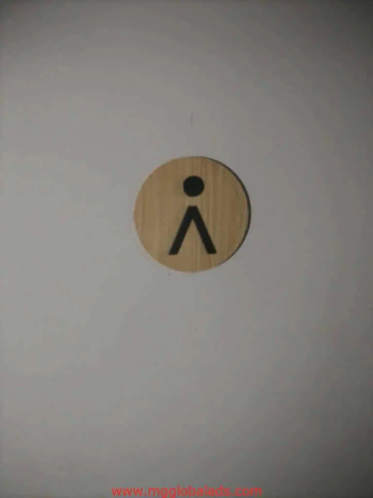 Minimalist wooden stick figure outdoor sign for Makati cafe, wall-mounted, unique business signage by M&G Global Ads.