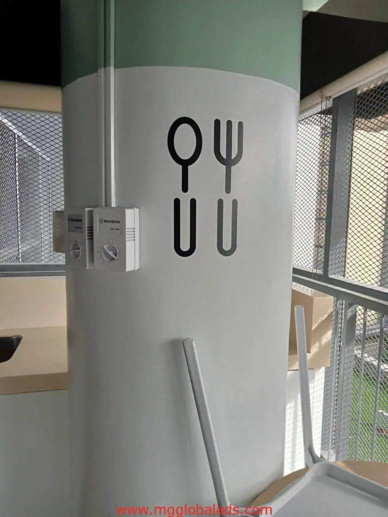 LED signage and a white and green pillar with utensil icons in a Makati eatery setting by M&G Global Ads.