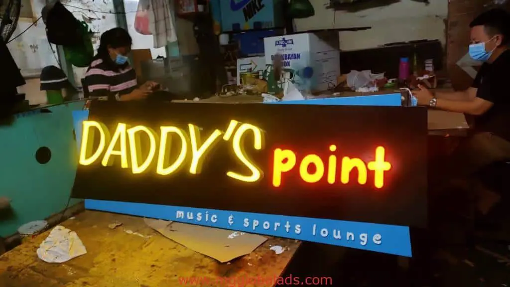 Neon LED signage assembly for DADDYS point music & sports lounge in Quezon City indoor workspace by M&G Global Ads.