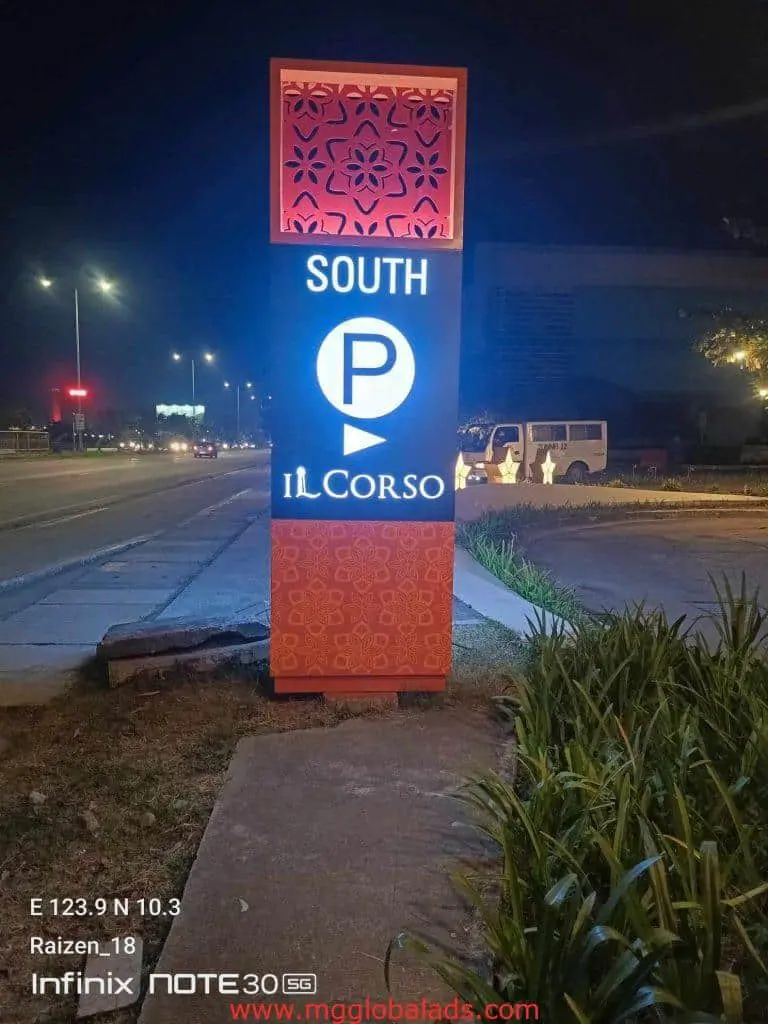LED signage for SOUTH P IL CORSO with orange patterns by a Makati road at night, cars and plants nearby, by M&G Global Ads.