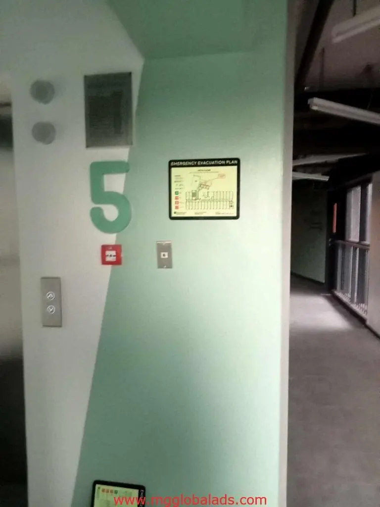Acrylic number 5 signage, fire alarm, elevator call button, evacuation plan in a Makati hallway by M&G Global Ads.