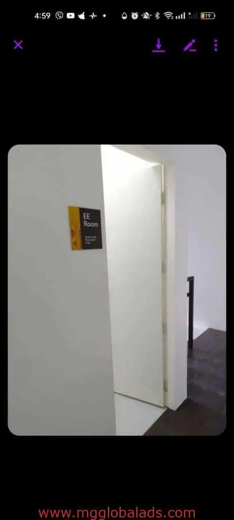 Acrylic room signage for EE Room with smaller text, white door and walls in Makati office. By M&G Global Ads.