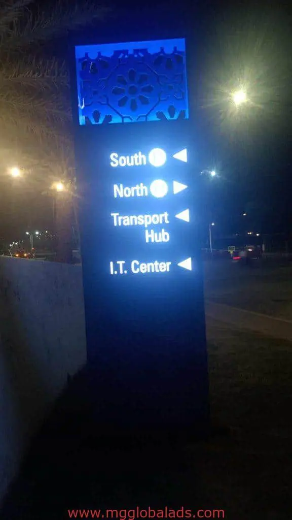 LED wayfinding signage at night in Makati showing directions to South, North, Transport Hub, I.T. Center by M&G Global Ads.