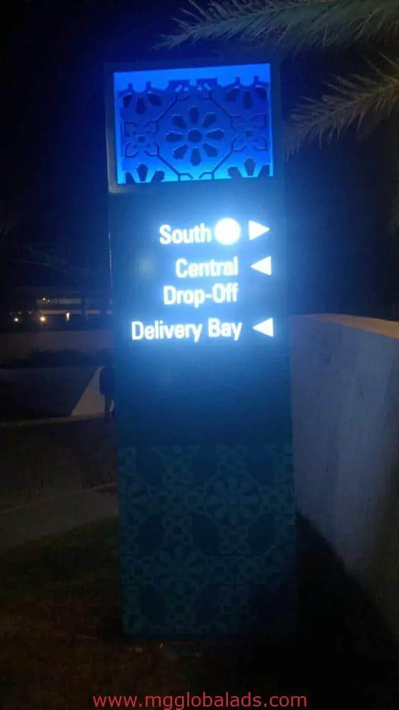 LED directional signage in BGC at night with arrows for South, Central, Drop-Off, Delivery Bay, decorative accents by M&G Global Ads.