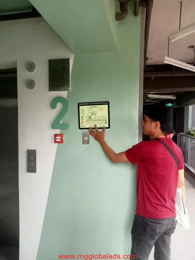 Metallic emergency evacuation plan signage installation by elevator, second floor, Mandaluyong location by M&G Global Ads.