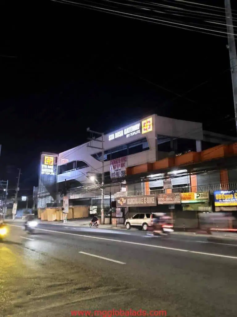 Illuminated acrylic signage for Santa Rosa Gateway Mall and Kuromaki E-Bike in Makati at night, by M&G Global Ads.