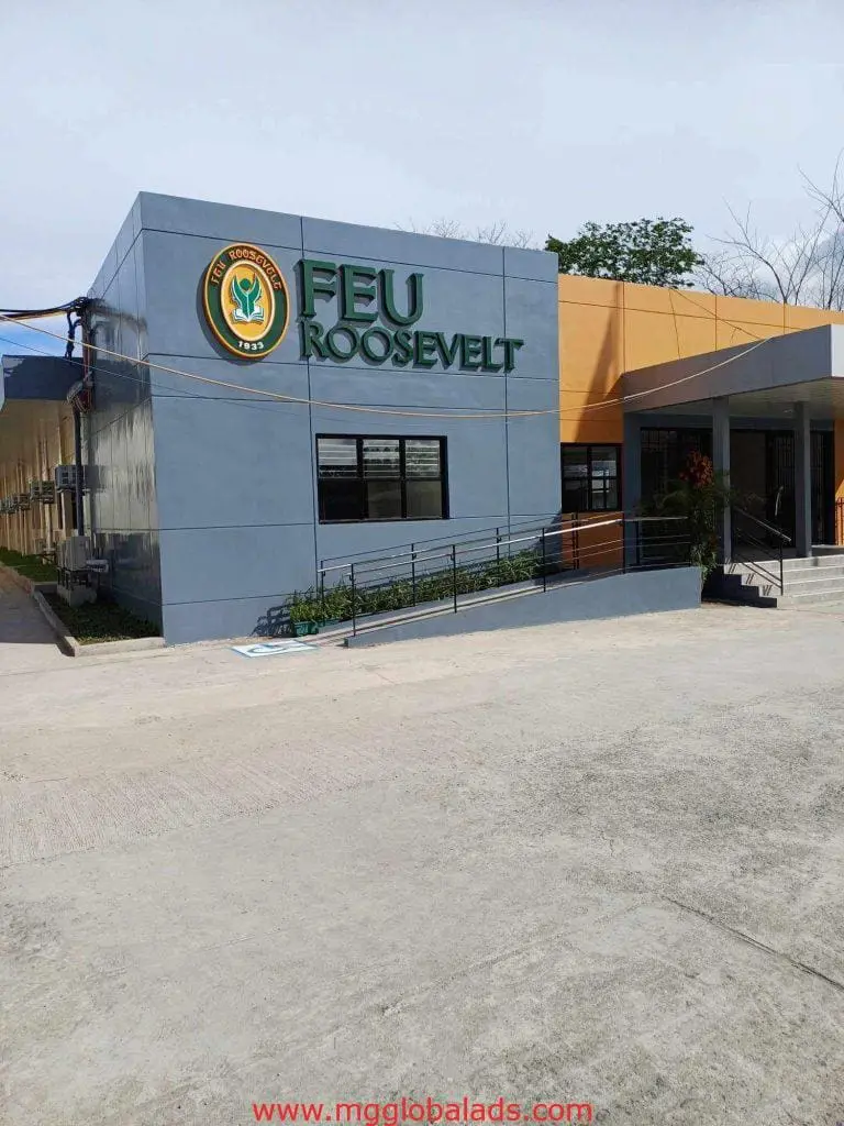 FEU Roosevelt pylon signage on modern gray-orange building, ramp and steps at entrance in Mandaluyong by M&G Global Ads.