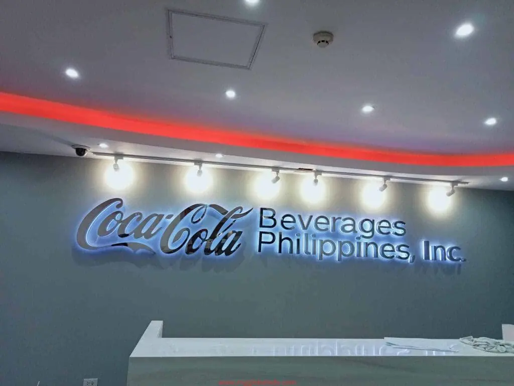Acrylic office signage for Coca-Cola Beverages Philippines, Inc. in a modern Makati reception area by M&G Global Ads.