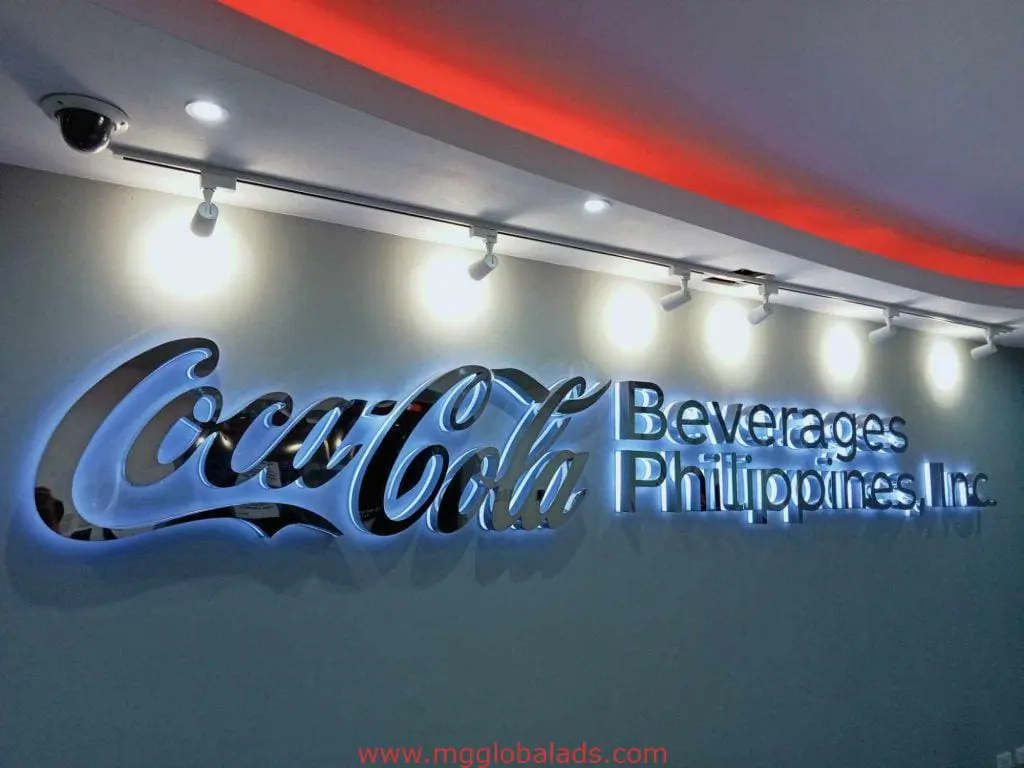 Illuminated indoor signage for Coca-Cola Beverages Philippines in metallic letters, Makati location, by M&G Global Ads.