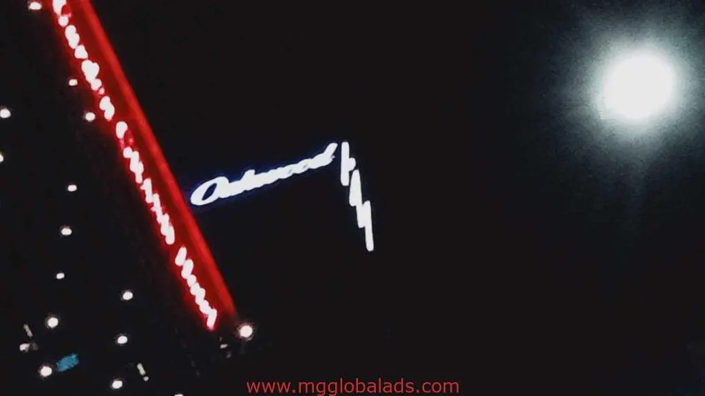 Metallic building signage for Oakwood in cursive with red lights, full moon, Ortigas location by M&G Global Ads.