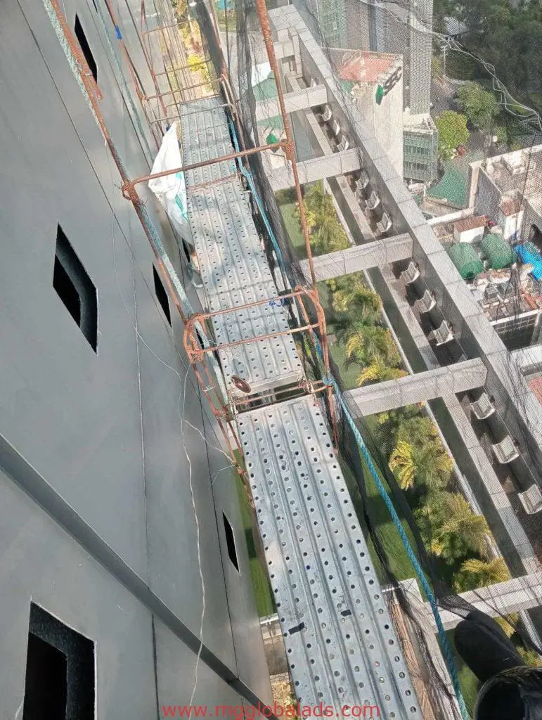 Outdoor billboard signage installation for a commercial client in Ortigas, metal scaffold on tall building by M&G Global Ads.