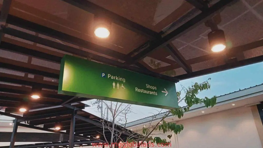 Wayfinding outdoor signage for shops, parking, and restaurants in Makati under LED-lit walkway by M&G Global Ads.