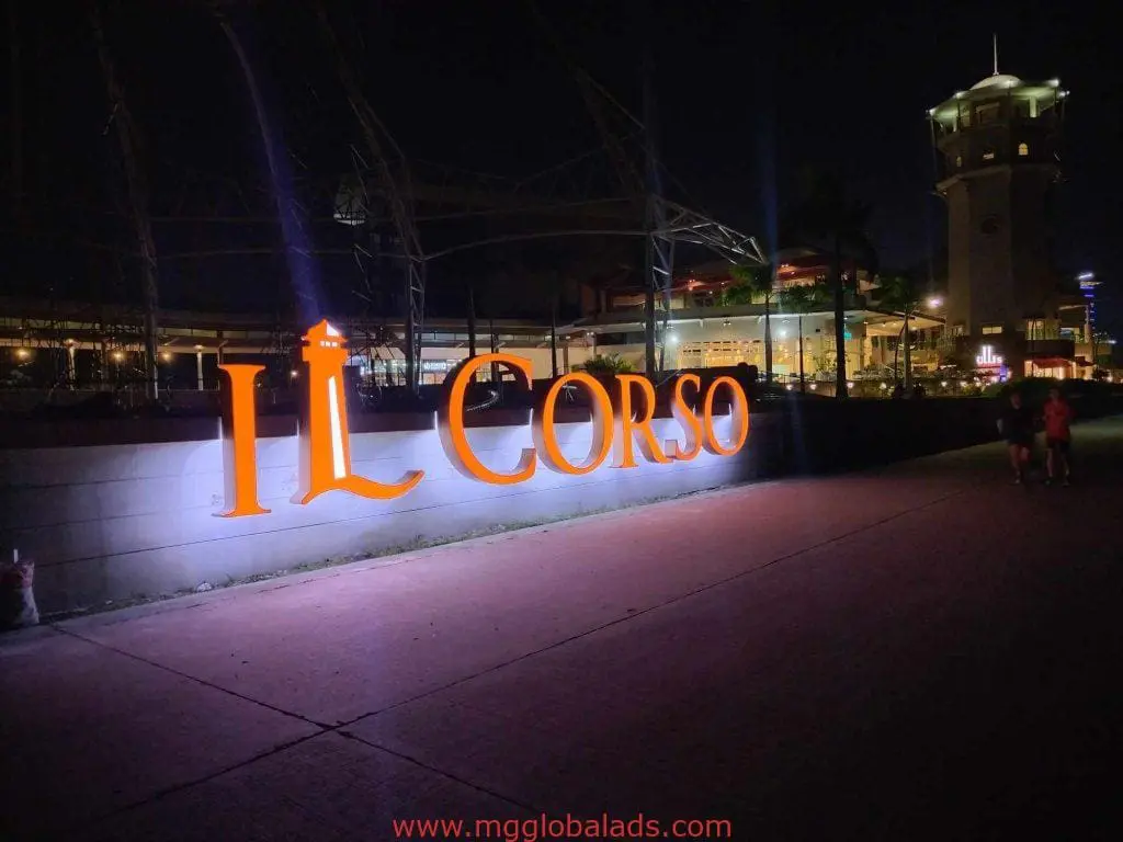 IL CORSO acrylic illuminated signage at night in Makati with outdoor signs, buildings, and a lit tower by M&G Global Ads.