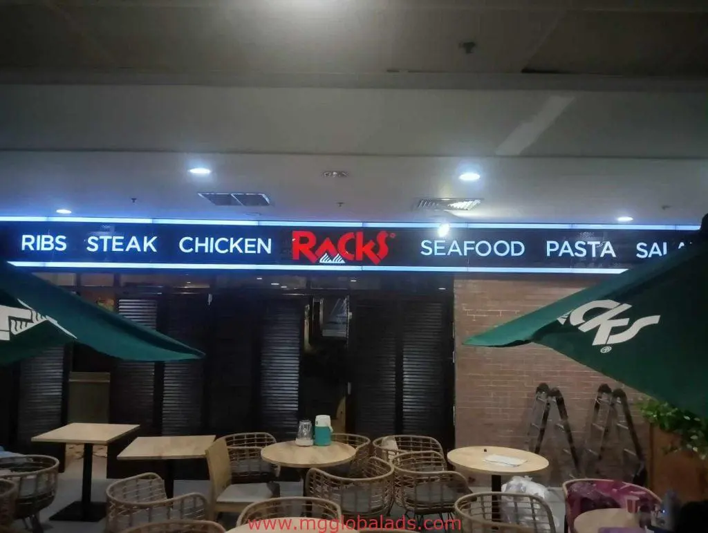 RACKS restaurant outdoor seating, menu board signage in Makati shows ribs, steak, chicken. Signage by M&G Global Ads.