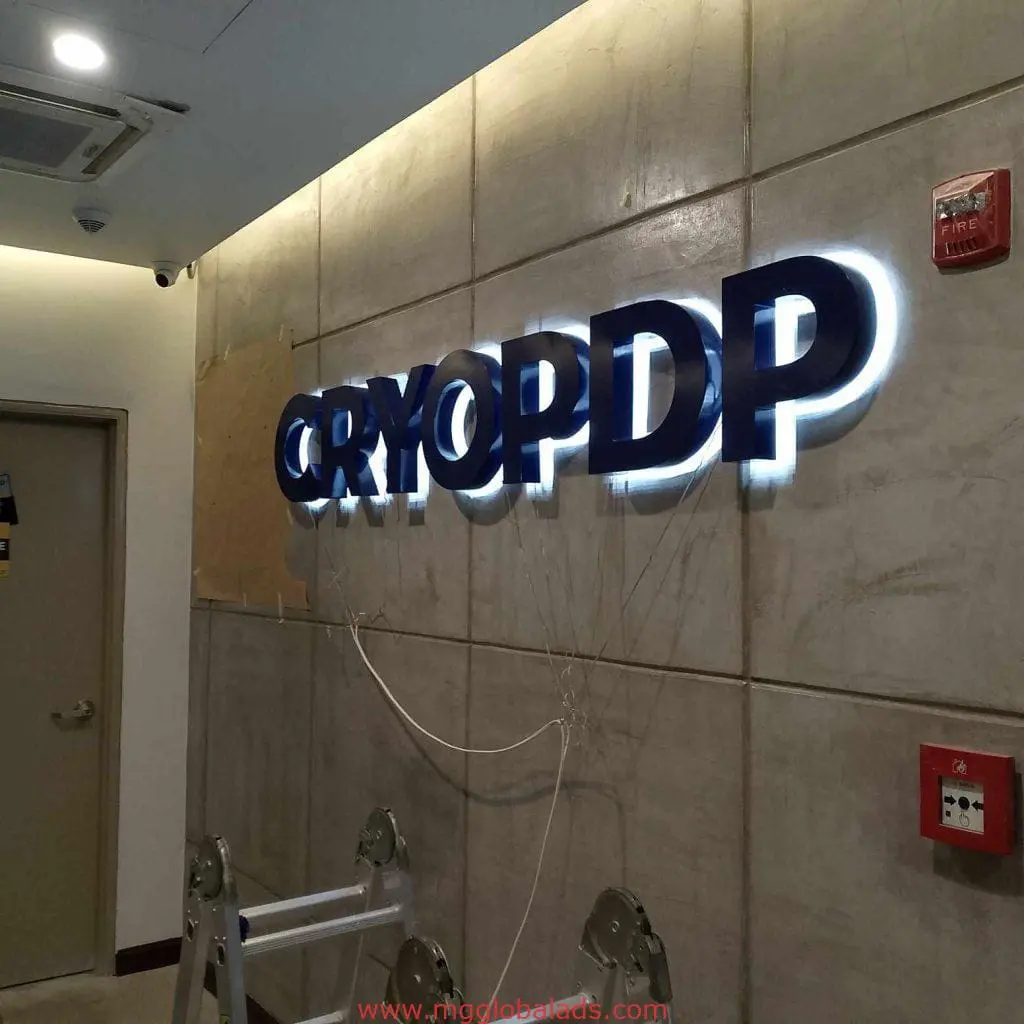 Indoor illuminated blue acrylic LED signage for CRYOPDP in Quezon City, M&G Global Ads. Fire alarm and extinguisher nearby.