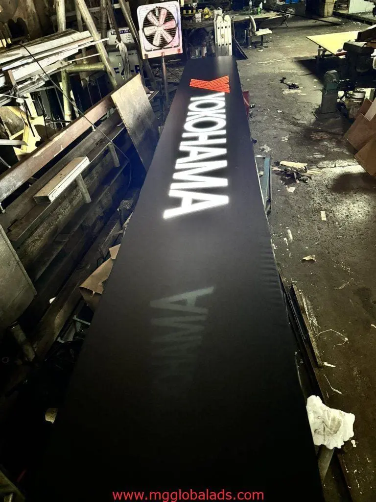 Yokohama LED signage with red triangle logo for client in Quezon City, displayed in workshop by M&G Global Ads.