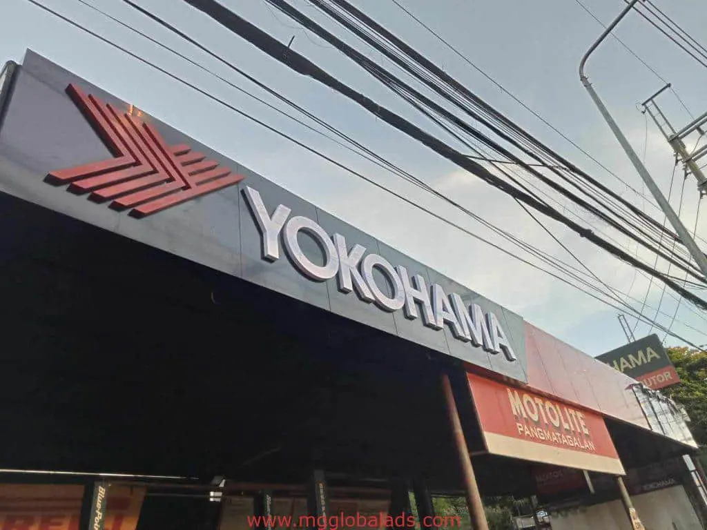 Yokohama LED storefront signage and red arrow logo in Mandaluyong, visible beneath power lines, by M&G Global Ads.