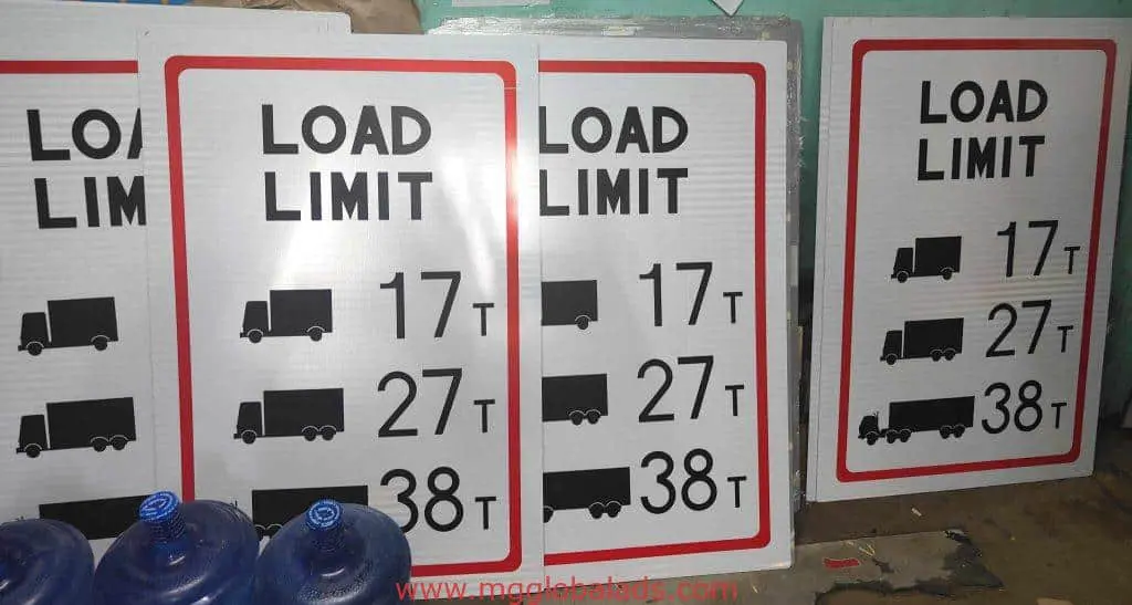 Metallic road signage for truck load limits in Quezon City, showing 17T, 27T, 38T; water jugs in front. by M&G Global Ads.