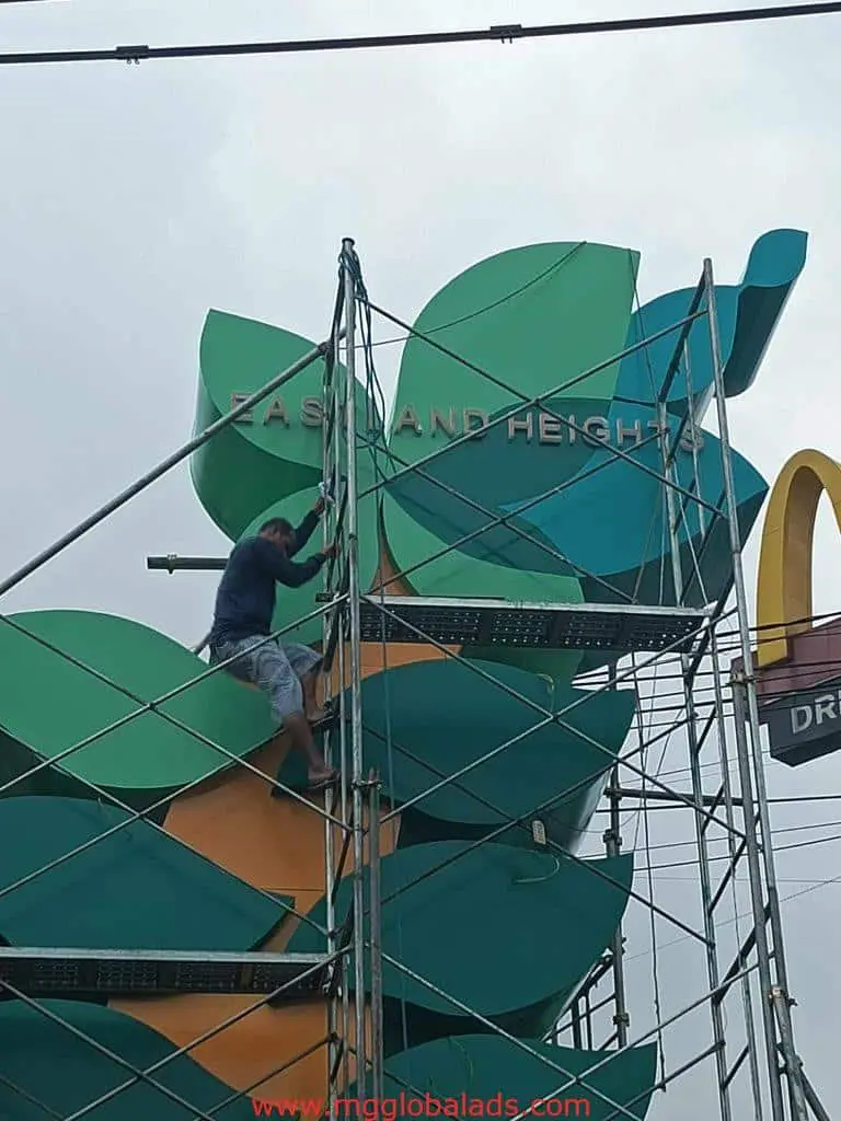 Leaf-shaped EASTLAND HEIGHTS building signage installation with McDonalds sign in Quezon City by M&G Global Ads.