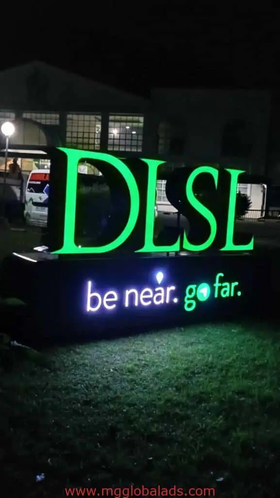 Illuminated acrylic DLSL outdoor signage with be near. go far. in green and white, seen in Makati, by M&G Global Ads.