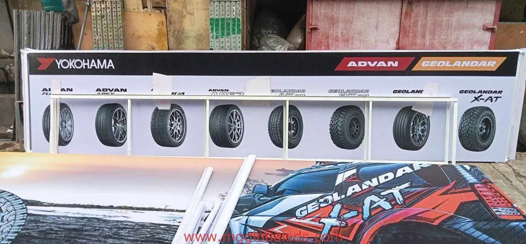 Indoor signage display for Yokohama tires at a Makati showroom with tire models and car graphic, by M&G Global Ads.