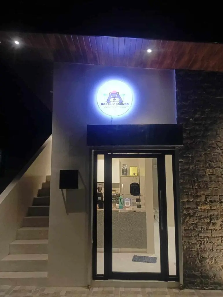 LED signage for Barks & Boudoir at a modern building entrance in Ortigas, glass doors, stone wall—by M&G Global Ads.