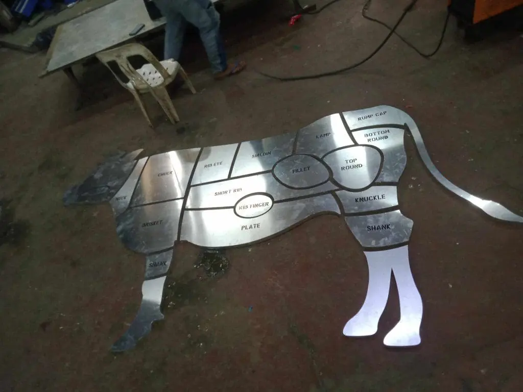 Metallic beef cuts signage for restaurant in Quezon City, showing labeled cow sections on floor, by M&G Global Ads.