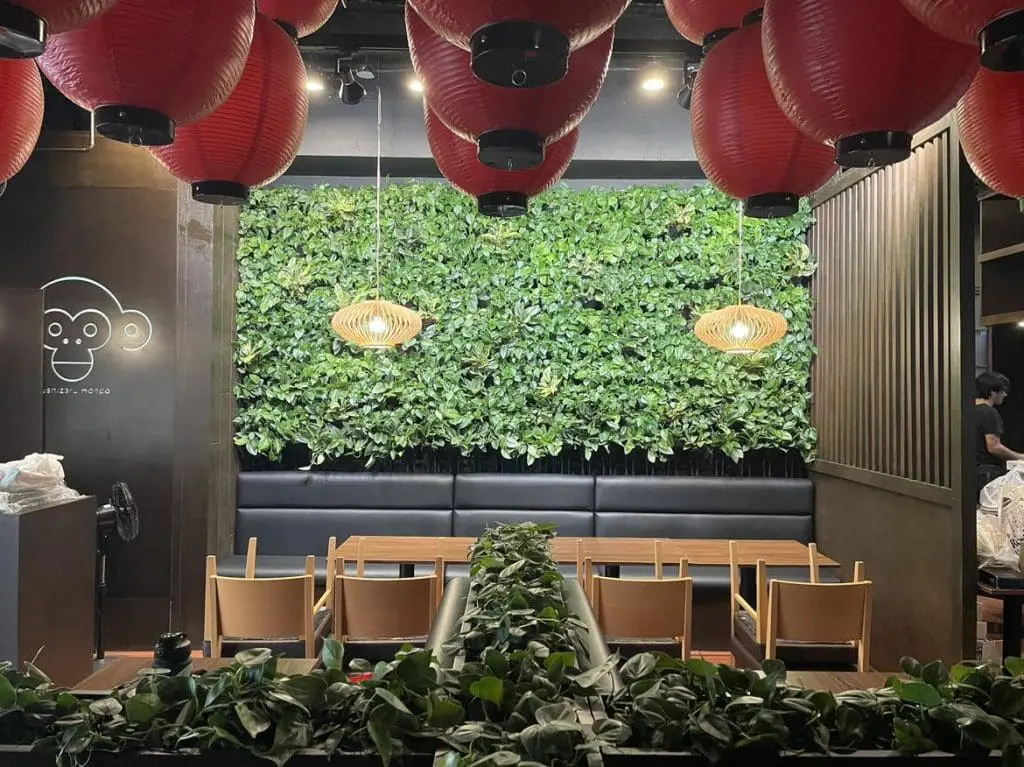 Restaurant Greenwall and Moss Wall with cartoon monkey logo for Monkey Eats in Makati by M&G Global Ads; red lanterns, plant wall.