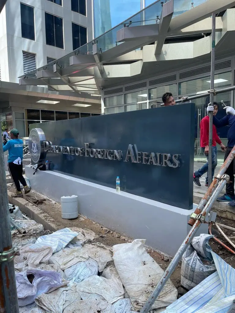 Team installs vibrant acrylic signage for a business in Makati, Metro Manila by M&G Global Ads.