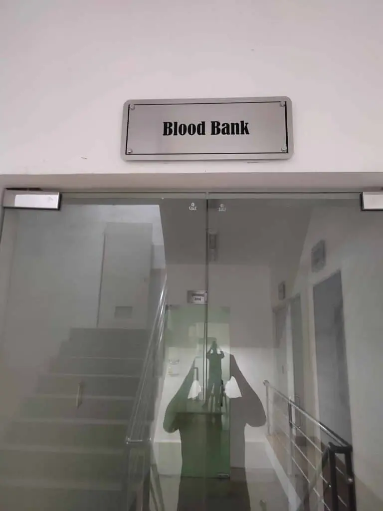 Blood Bank illuminated sign for clinic in Makati, glass door entrance with reflection, by M&G Global Ads.