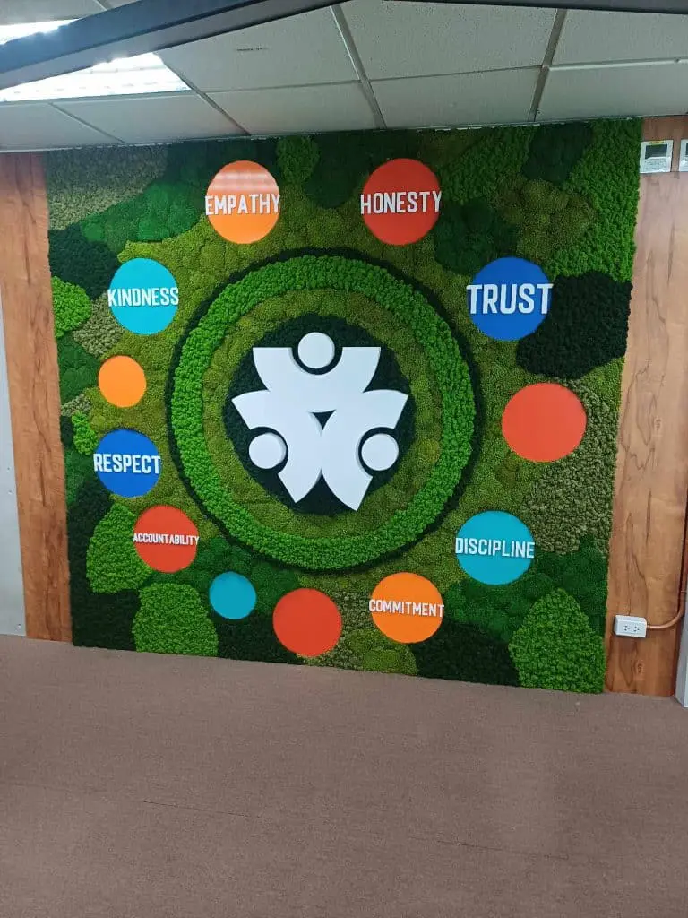 Acrylic wall signage with white abstract people logo and colorful values circles in Makati, by M&G Global Ads.