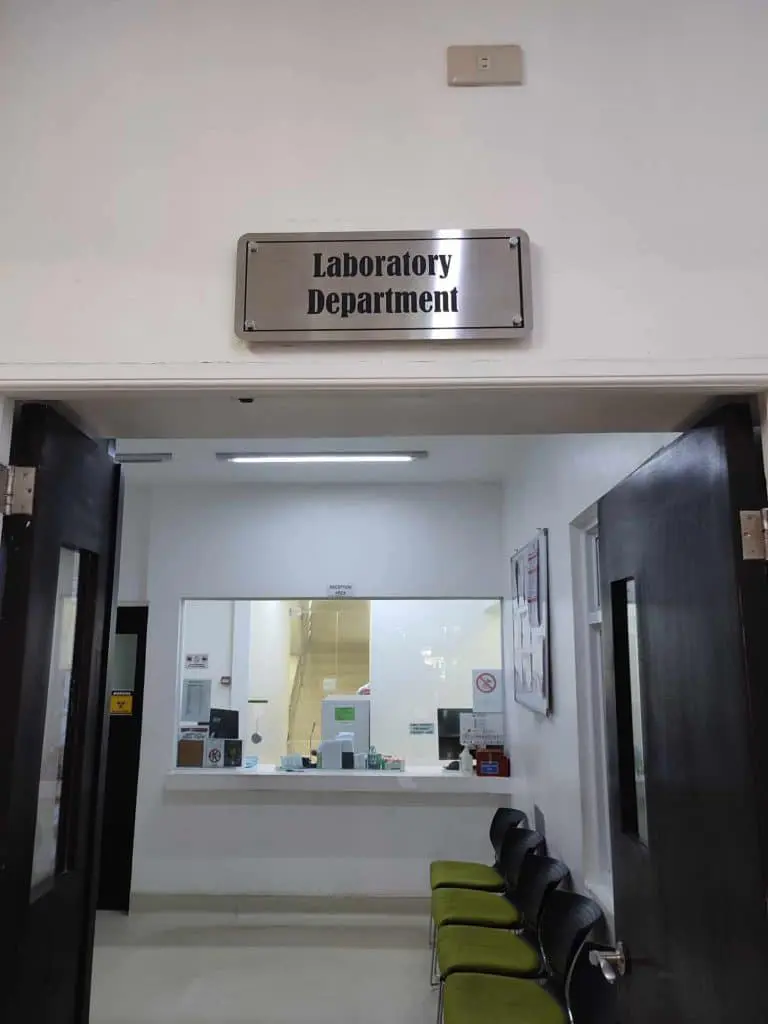 Indoor LED signage for Laboratory Department above double doors in Makati, green chairs by counter; by M&G Global Ads.