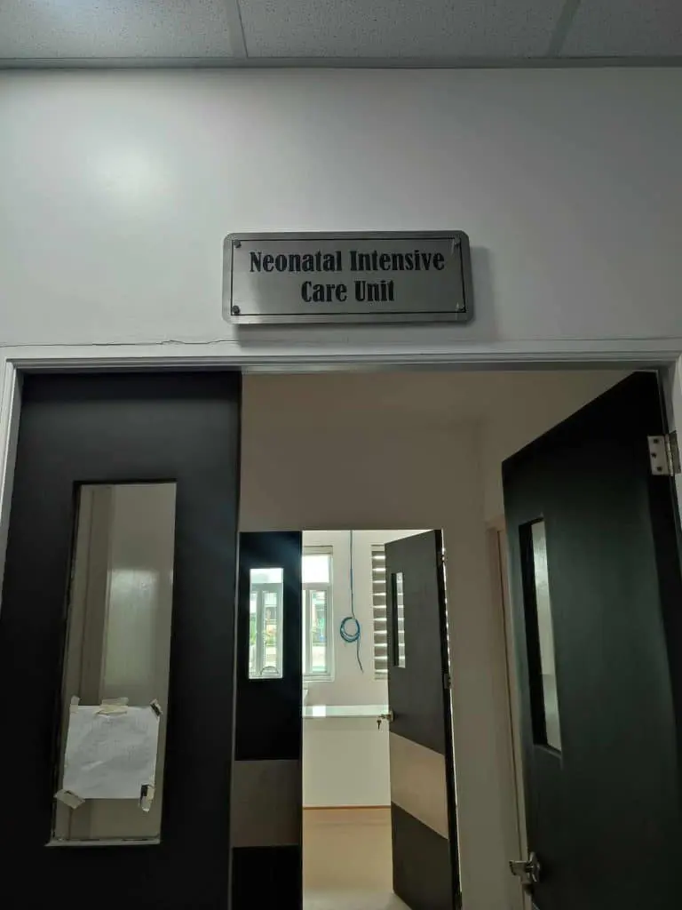 Neonatal Intensive Care Unit stainless engrave hospital sign above doorway in Pasig, bright interior visible, by M&G Global Ads.