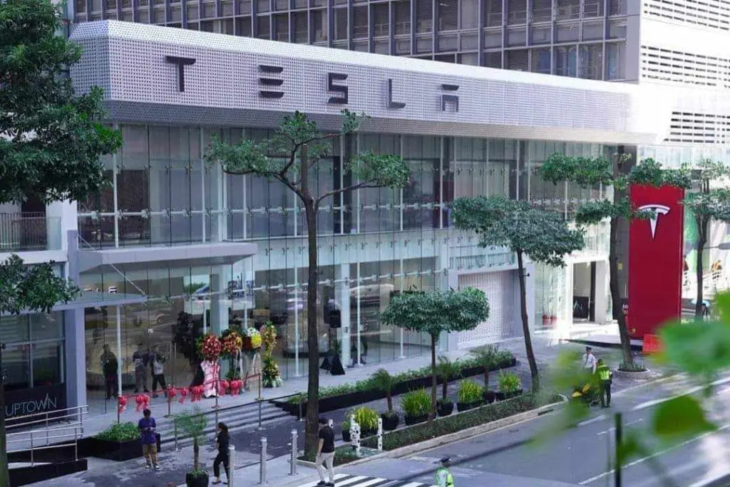 Tesla illuminated building acrylic signage for showroom with glass facade in Makati city street by M&G Global Ads.