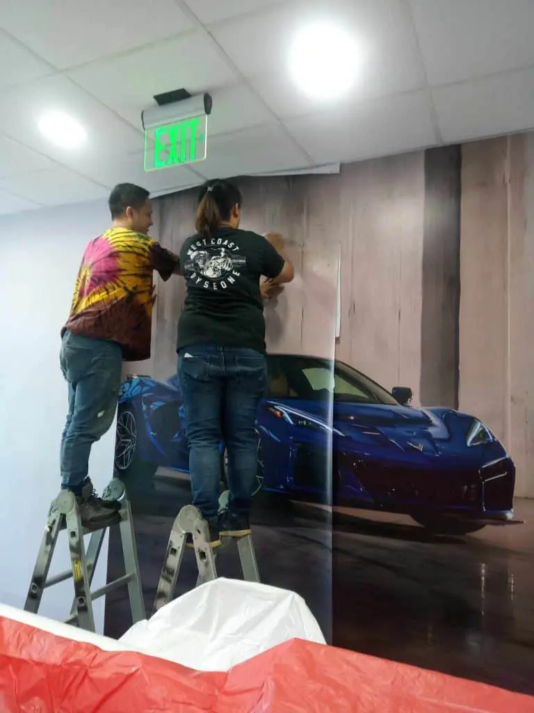 Wall mural indoor signage installation with blue sports car, Quezon City project by M&G Global Ads.