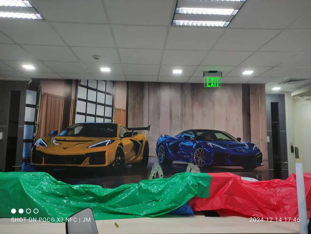 Custom indoor signage wall mural of yellow and blue sports cars in Makati garage by M&G Global Ads.