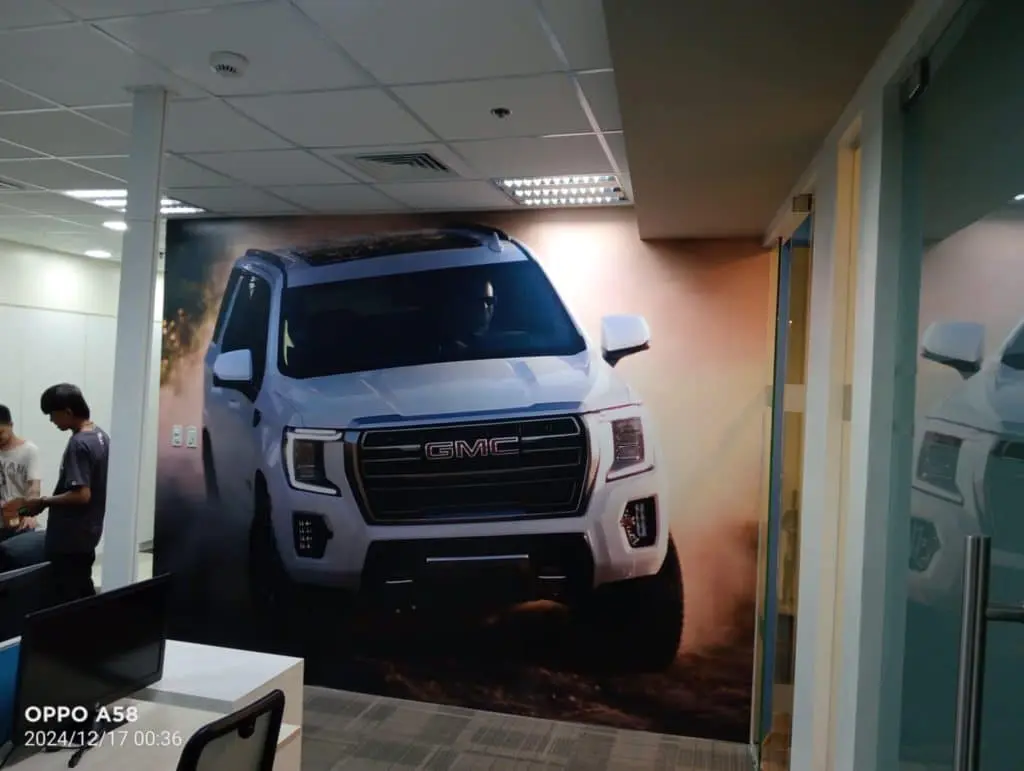 Acrylic signage mural for GMC in a modern Quezon City office with glass walls and ceiling lights, by M&G Global Ads.