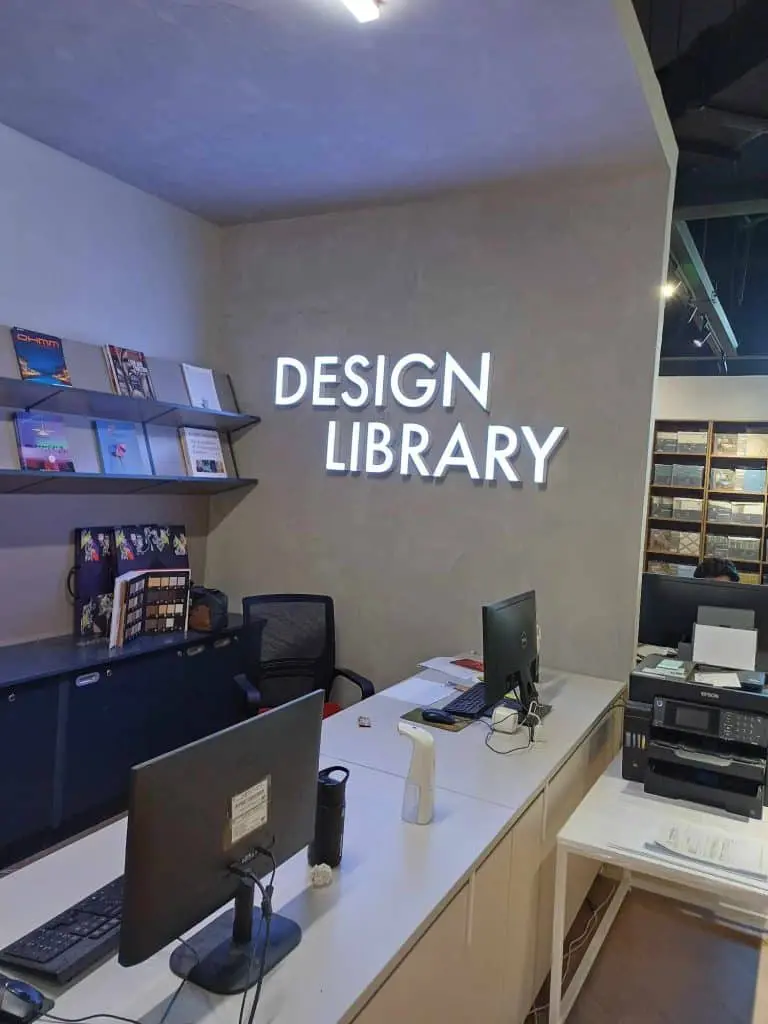 LED indoor signage for DESIGN LIBRARY in a modern office, Makati, with workstations and book shelves by M&G Global Ads.