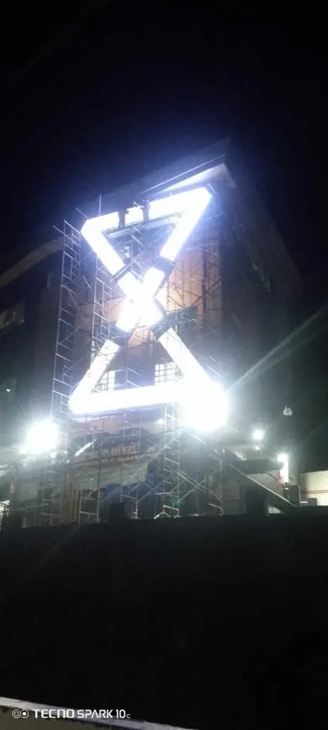 Hourglass-shaped LED outdoor signage on a Makati building at night with bright white lights, by M&G Global Ads.