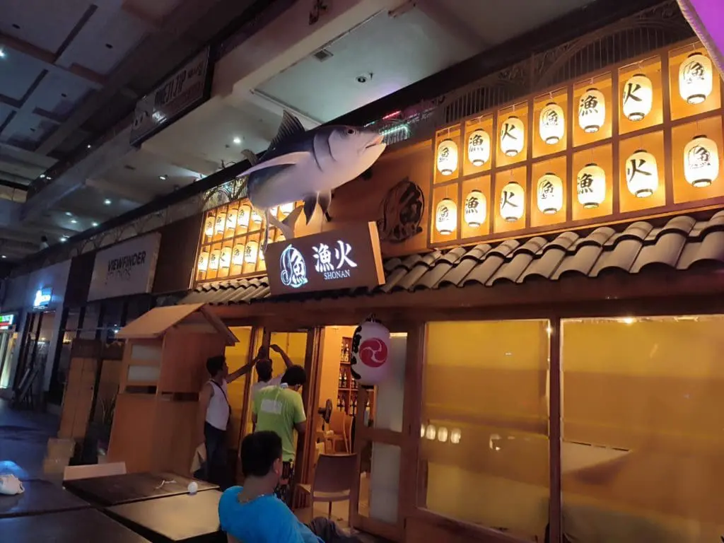 Japanese restaurant LED signage and lanterns in Makati, bright night scene with fish statue and diners by M&G Global Ads.