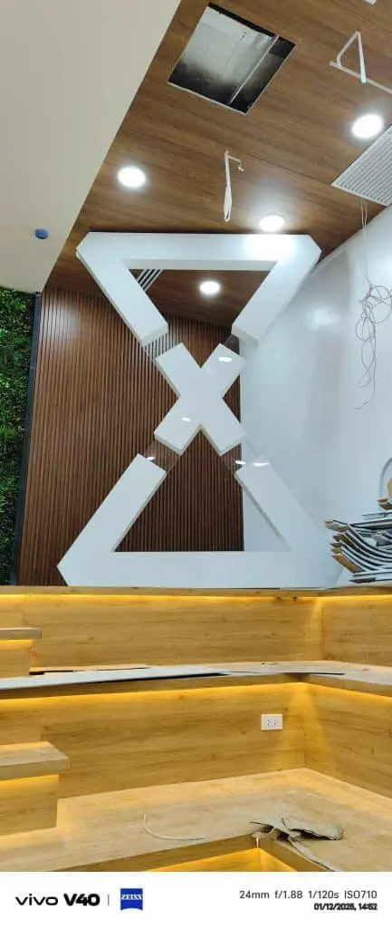 Modern interior with wooden accents, geometric decor, acrylic signage in Mandaluyong office setting by M&G Global Ads.